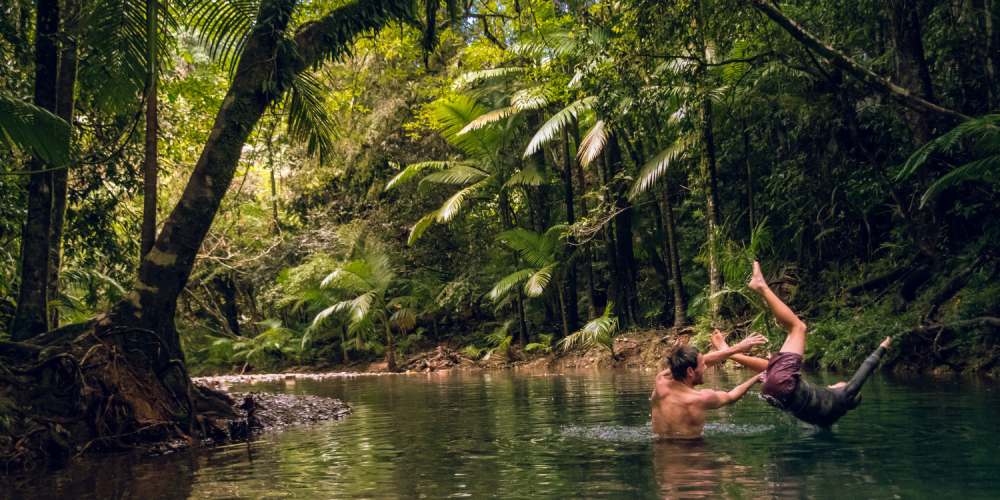 Family playing in the water in Daintree Rainforest